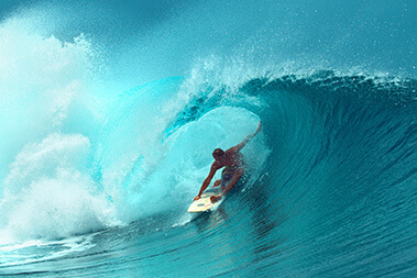 Man surfing the waves in the Kona Coast, Hawaii