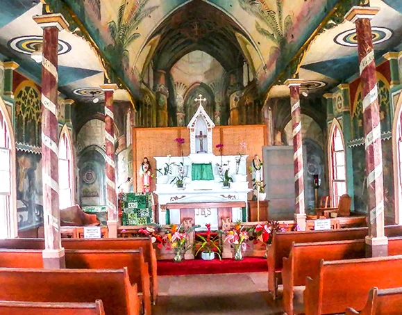 Colorful hand-painted interior murals and altar inside the historic Painted Church on the Big Island of Hawaii